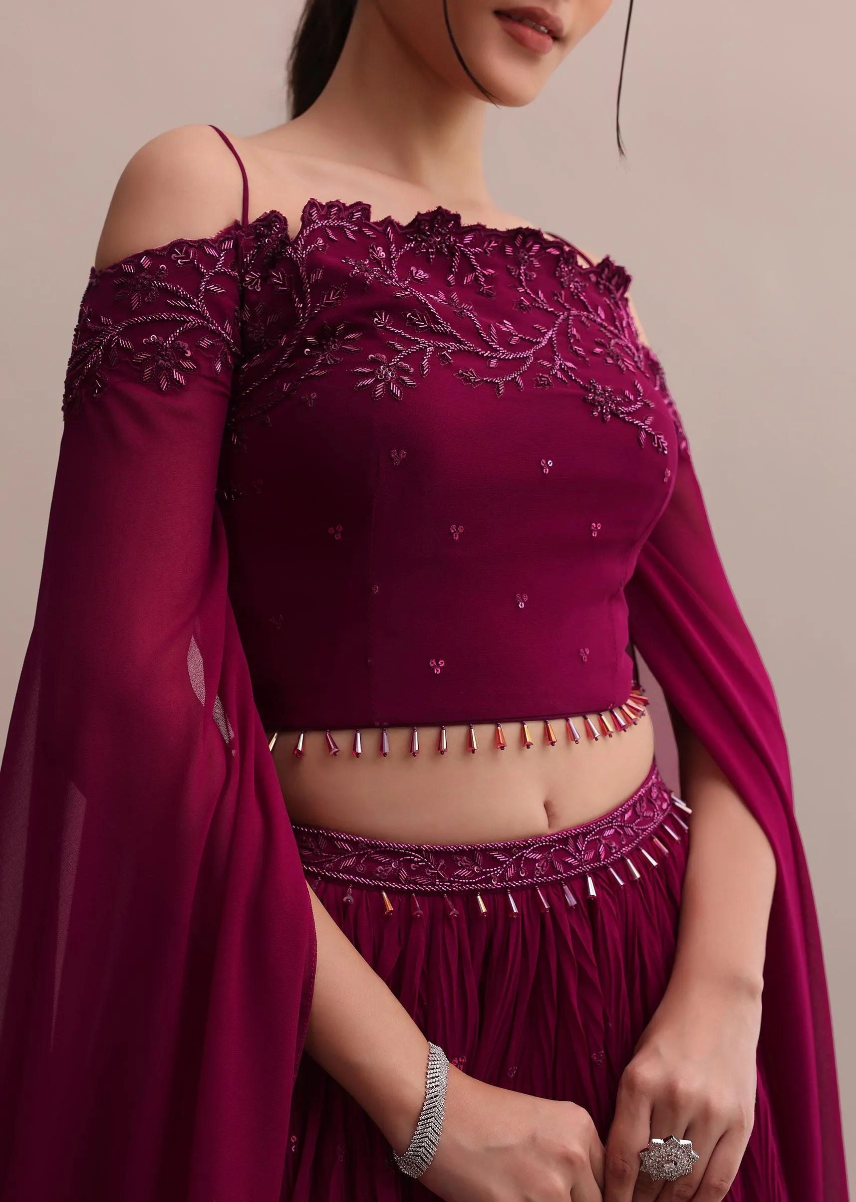 Lavish Wine Georgette Lehenga And Off-Shoulder Crop Top With Attached Cape