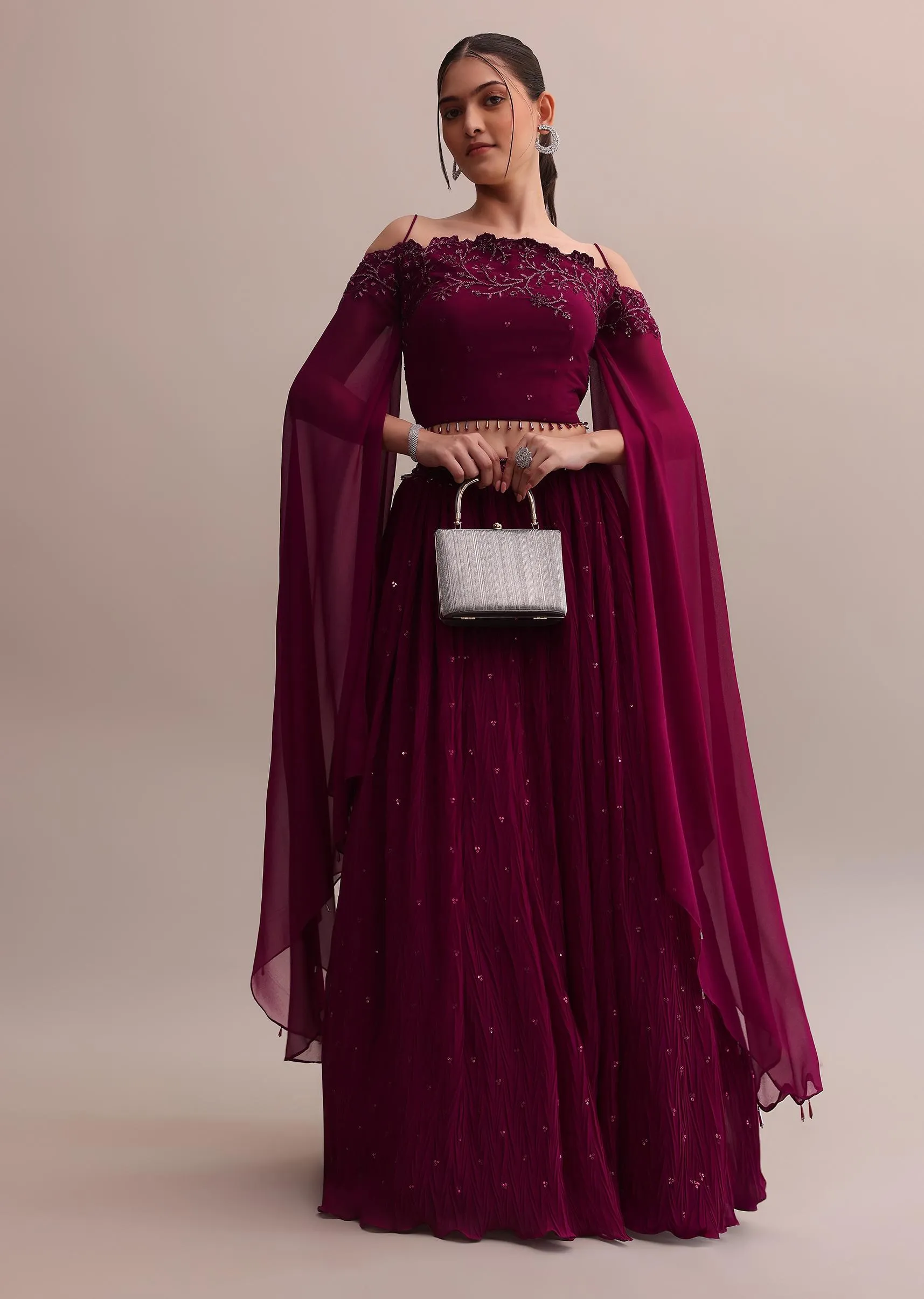 Lavish Wine Georgette Lehenga And Off-Shoulder Crop Top With Attached Cape